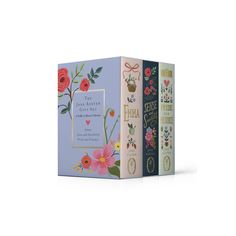 three books with floral designs on them, one in blue and the other in pink