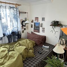 a bed room with a neatly made bed and lots of clutter on the floor