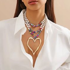 Glam Layered Necklace In Multicolor Beads And White Faux Pearls With A Large Gold Heart Pendant. Boutique Packaging Includes Storage Bag New To Poshmark? Use Code Emmiesbling For $10 Off Your Purchase When You Open A New Account. Check Out My Other Listings If You Like Boho Hippie 60’s 70’s 80’s 90’s Y2k Retro Mcm Pin-Up Beach Western Pool Coachella Festival Southwestern Bohemian Vintage Ig Instagram Tik Tok Gypsy Spell Vici Nasty Gal, Misguided, House Of Cb, Quay, Windsor, Lulus, H&M, Forever 2 Big Heart Necklace, Color Heart, Estilo Boho Chic, Heart Shaped Necklace, Multi Layer Necklace, Heart Pendant Gold, Styl Boho, Vintage Heart, Colourful Necklace