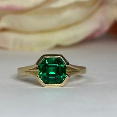 "The ring pictured is lab created emerald #7172 Also shown in 14k white gold Rose Gold is available upon request as a custom order and is a final sale (non refundable, non returnable, non exchangeable). -Approximate total carat weight: approx. 1.75ctw diamond equivalent -Center Stone Size: 7x7mm - approx. 1.75ct diamond equivalent -Center Stone Shape: asscher cut -Gem Type: lab created emerald -Stone Clarity: VS2 -Stone Color: Green -Moh's Scale: 8.5 hardness -Metal Type and Purity: 14k yellow g Timeless Green Emerald Ring Stamped 14k, Formal Emerald Solitaire Birthstone Ring, Formal Octagon Emerald Ring With Bezel Setting, 14k Gold Octagon Emerald Ring, Formal Octagon Solitaire Emerald Ring, Timeless Asscher Cut Emerald Promise Ring, Formal Emerald Birthstone Ring With Center Stone, Classic Emerald Cut Birthstone Ring Stamped 14k, 14k Gold Octagon Emerald Ring With Bezel Setting