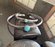 "Looking for The perfect gift for Mom and baby? These matching turquoise cuff sets are absolutely precious! Beautiful Kingman Turquoise and Sterling Silver adjustable floral pattern Cuff Bracelet for Mom and Baby! 8mm Kingman Turquoise for Mom with your choice cuff length and 5mm Turquoise for baby on a 4\" cuff that fits newborn to 1 year and adjustable. 💕 This is a dainty yet sturdy .925 Sterling Silver floral pattern cuff and is 3.55 wide x 1.55mm thick. (A stronger version than my original design to provide more strength) I will hand cut, hand shape, lightly hammer, lightly oxidize, tumble for hours, set stone and hand-polish just for you! My cuffs are made to order in your size.  My Kingman turquoise is from the same batch and may vary slightly in color but are all a luscious turquoi Adjustable Stackable Turquoise Cuff Bracelet, Adjustable Turquoise Cuff Bracelet As Gift, Turquoise Stackable Bracelets As Gift, Handmade Turquoise Bangle For Gift, Adjustable Turquoise Bangle As A Gift, Turquoise Bangle Cuff Bracelet Gift, Turquoise Cuff Bracelets, Mother And Newborn, Bracelet For Mom