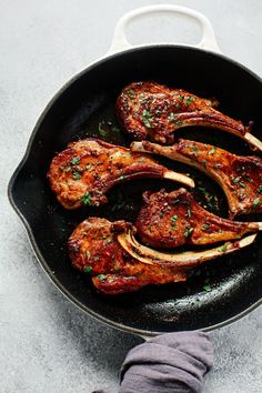 some meat is cooking in a pan on the table