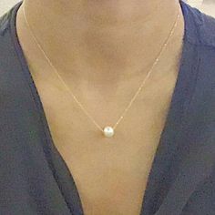 A beautiful, dainty floating pearl necklace made of 9ct yellow gold. The pearl is a genuine cultured freshwater pearl. It is 8mm in diameter and has been hand drilled to float on a 0.75mm delicate 9ct gold chain. Chain length can be chosen from the drop box at checkout. Pearl is the birthstone for June and so this stunning necklace would make the perfect gift for a June baby. Pearl also represents the 30th anniversary of a special bond and can be given as an anniversary present to signify the be Minimalist 14k Gold Pearl Necklace With Pearl Charm, Minimalist 14k Gold Pearl Necklace Gift, Minimalist 14k Gold Necklace With Pearl Charm, Minimalist Yellow Gold Pearl Necklace With Round Pendant, Minimalist 14k Gold Pearl Pendant Necklace, Minimalist 14k Gold Pearl Necklace, Minimalist Yellow Gold Pearl Necklace, Dainty Yellow Gold Pearl Pendant Necklace, Minimalist Yellow Gold Round Pearl Necklace