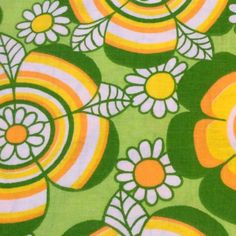 a green and yellow floral print fabric with white, orange, and yellow flowers on it