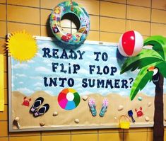 a bulletin board that says ready to flip flop into summer with beach balls and palm trees