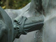 a close up of a horse's head on the side of a statue