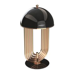 a black and gold table lamp on a white background with clippings to the side