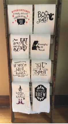 six white towels hanging on a rack with black and red words in them that read witch's kitchen, eat scary