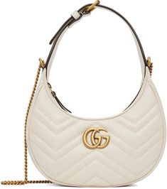 Quilted buffed leather shoulder bag in white. Logo hardware at face. · Adjustable pin-buckle carry handle · Detachable curb chain shoulder strap · Zip closure · Lanyard clasp and two card slots at interior · H6 x W8 x D2.5 in Supplier color: Mystic white | Gucci White Mini GG Marmont Bag White Gucci Bag, Gg Marmont Bag, Gucci Clothes, Bag Packs, Favorite Purse, Etsy Promotion, Fashion Vibes, Gucci Outfits, Pinterest Ideas