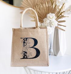 "Floral Monogram Tote Bags make a great gift for bridesmaids or friends over the holidays! Monogrammed burlap bags are customized with a beautiful floral initial of your choice. Each monogram has a vintage \"stamped\" finish - no two are alike. Details This listing is for 1 Monogram Tote Bag with a VINTAGE STAMPED FINISH. Size: 12\" x 12\" with 7.75\" gusset 100% Burlap Fabric with laminated interior LISTING IS FOR Tote Bag ONLY - NO OTHER ITEMS WILL BE SHIPPED. Print is on ONE side ONLY. Be sur Valentine Gift Bags, Unique Bridal Shower Gifts, Shopping Tote Bags, Valentines Gift Bags, Burlap Tote Bags, Burlap Tote, Holiday Gift Bag, Burlap Bags, Monogram Tote Bags