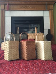 four baskets sitting on top of a bed next to a fireplace