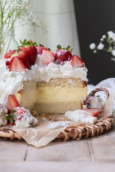 a cake with white frosting and strawberries on top