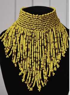 A bold African beaded choker necklace with an adjustable neck size. This necklace is authentic enough to make a statement. * 100% handmade. * maximum fringe length - 4.5inches/11.5cms * neck width - adjustable *Shipping - Please allow 7 to 10 business days for the item to be shipped due to make and processing time. Afro Futurism, African Beads Necklace, Cowrie Shell Necklace, African Print Clothing, Handmade African, Black Choker, African Beads, Beaded Choker Necklace, Futurism