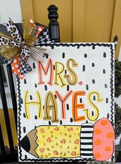 a sign that says mrs hayes and has an ice cream cone on it next to a door