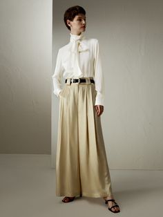 Our Wide-Leg Pant is crafted from luxurious watershine silk fabric, providing the perfect combination of breathability, softness, and incredible glossiness. With a classic design featuring a high waist, wide legs, and front pleating, these pants combine style and comfort effortlessly. Versatile and essential, our watershine silk pants are suitable for any occasion, be it a special event or a professional work meeting. Silk Wide Leg Pants, Silk Pajamas Women, Silk Bedding Set, Camisole Set, Striped Midi Skirt, Work Meeting, Silk Knit, Round Neck Sweaters, Silk Pants