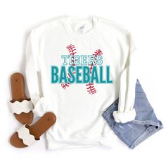 "Baseball Sweatshirt, Baseball Mom Shirt, Custom Baseball Shirts for Women, Personalized Baseball Sweater, Baseball Team Tees, Baseball Gift This custom baseball sweatshirt is so soft, comfy & stylish and perfect to keep you warm and cozy for baseball game day! HOW TO ORDER:  Please leave the team\\mascot name, and the font & font outline colors you would like in the \"Add your personalization\" text box. Please message me if you have any questions before ordering. This UNISEX sweatshirt will last for years. Good quality material that needs no ironing. All inks used to print are high quality, water-based and eco-friendly. 50/50 cotton/polyester 8.0 oz. fabric weight Reduced pilling and softer air-jet spun yarn All products are made-to-order. Colors may vary slightly from one computer/phone Varsity Screen Print Tops For Sports Season, Varsity Style Screen Print Tops For Sports Season, White School Spirit Sweatshirt For Baseball Season, White School Spirit Sweatshirt For Sports Season, Team Spirit Cotton Tops With Lettering, Varsity Tops With Lettering For Sports Season, Varsity Sports Top With Lettering, Varsity Style Tops With Lettering For Sports Season, Crew Neck Tops With Team Spirit Lettering