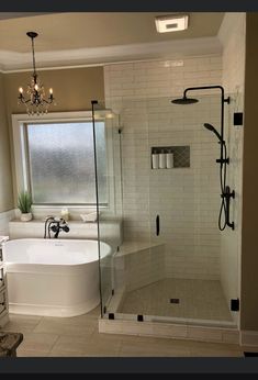 a bathroom with a tub, shower and sink in it's own area is shown