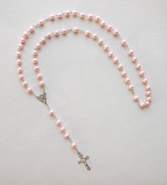 This listing includes (1) rosary. Acrylic pink beads with detailed Crucifix 1-1/2" long. SIZE/LENGTH: Total length is 22" including the Crucifix BEADS: Quality 8 mm (5/16") acrylic round beads carefully assembled on a zinc alloy chain. CENTER:  Zinc alloy center piece of The Madonna measures 1/2" x 5/8" CRUCIFIX: The Crucifix measures 1-1/2" L x 7/8" W. ALL LINKS HAVE BEEN CHECK ONE BY ONE BEFORE SHIPPING THIS ROSARY...HOWEVER IT HAS NOT BEEN DESIGNED TO USE AS A NECKLACE ROSARY AND YOU SHOULD INSTEAD USE CORD ROSARIES FOR THIS PURPOSE. HOWEVER IF YOU DECIDE TO USE IT AS A NECKLACE ROSARY WE WILL NOT BE RESPONSIBLE FOR ANY DAMAGE AND WE DON'T RECOMMEND IT Come Visit Us at Our New Store! Please feel free to email me with questions about this item. Also please check my other listings. I am a Pink Rosary With Round Beads For First Communion, Pink Rosary For First Communion, Pink Rosary With 8mm Round Beads, Pink Beaded Rosary With Round Beads, Pink 8mm Beads Crucifix Jewelry, Adjustable Pink Cross Rosary, Pink Beaded Rosary, Pink Rosary, Acrylic Pink