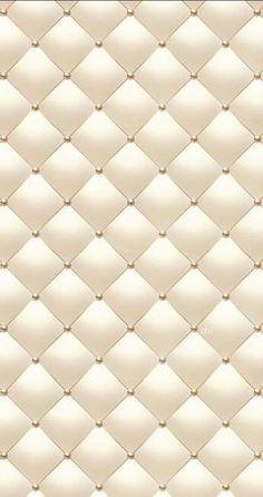 an upholstered white leather background with gold rivets on the top and bottom