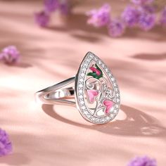 Reminiscent of the delicate garden, this ring has been carefully hand crafted in sterling silver, paying close attention to the intricate design of the flower. Bringing ring to life is cool leaf green and pink enamel detail. Bold on it own or great when paired with other complementary jewellery, this ring is incredibly versatile.Carat Weight: 2.25 ctStone Size: 1.5 mmNumber of Stones: 30 Stone Shape: RoundStone Color: Diamond WhiteWeight: 4.57 gWidth: 2.6 mmHeight: 6.1 mmThickness: 1.2 mmMaterial: 925 SilverPlating Color: Silver Pink Sterling Silver Flower Ring As Gift, Pink Sterling Silver Flower Ring For Gift, Pink Flower Enamel Ring For Wedding, Sterling Silver Flower Ring In Pink, Pink Flower-shaped Sterling Silver Ring, Pink Flower Shaped Sterling Silver Ring, Pink Flower Sterling Silver Ring, Silver Flower Enamel Ring As A Gift, Enamel Flower Ring For Anniversary