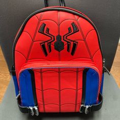 a spider man backpack sitting on top of a chair