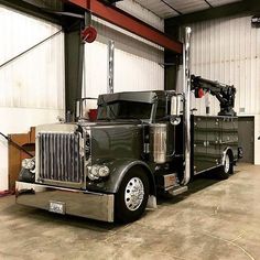 a large semi truck parked in a garage