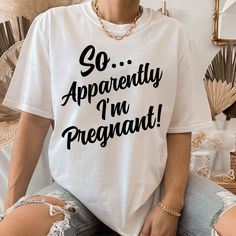 a woman wearing a t - shirt that says so apparently i'm pregnant