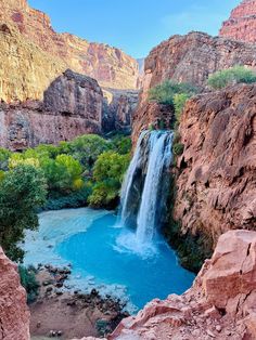 a waterfall in the middle of a canyon