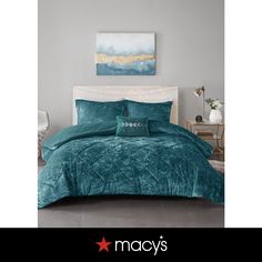 a bed with teal colored comforters and pillows