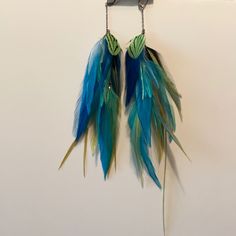 Very Colorful Blue And Green Saint Croix Bohemian Green Earrings With Peacock Design, Blue Feather Earrings As Gift, Blue Feather Earrings For Gift, Blue Feather Earrings, Elegant Blue Feather Earrings, Blue Feather Earrings Gift, Bohemian Green Feather Earrings, Adjustable Blue Feather Earrings, Louis Vuitton Earrings