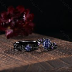 two wedding rings sitting on top of a wooden table