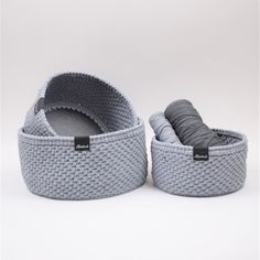 two gray baskets with handles on white background