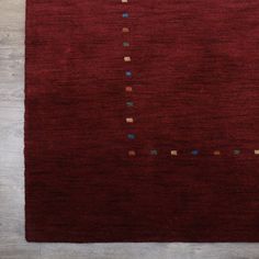 a red rug with small squares on it