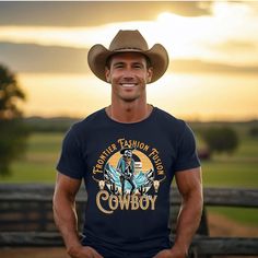 Saddle up for style with our Cowboy Adventure Graphic Tee! Embrace the rugged charm of the Wild West with this uniquely designed shirt. Whether you're a country soul or a city slicker longing for a frontier vibe, this shirt brings the cowboy spirit to your wardrobe. Crafted with care, it's perfect for casual outings, rodeo nights, or simply adding a touch of rustic flair to your everyday look. Key Features Comfortable Fabric: ☁️ Made from soft, breathable material for all-day comfort. Versatile Style: 🌵 Perfect for casual wear, line dancing, or pairing with your favorite denim. Unisex Fit: 👫 Tailored to flatter all, ensuring a comfortable and confident wear. Western Crew Neck Tops For Country Events, Western Style T-shirt For Rodeo, Western Style T-shirt For Ranch In Summer, Country Style T-shirt For Western-themed Summer Events, Pre-shrunk T-shirt For Western-themed Summer Events, Western Style T-shirt For Fall Western-themed Events, Western-style T-shirt For Western-themed Fall Events, Graphic Tee For Western-themed Fall Events, Western Style Summer T-shirt