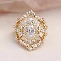 a diamond ring is sitting on a white cloth