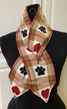 a scarf with hearts and paw prints on it