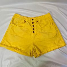 Vintage 90's LEI high waisted yellow denim shorts. The shorts are 100% cotton. They have a button fly with LEI logo buttons and gold hardware.  The shorts are in fair condition. There is a light orange spot on the front and the fly buttons have bled rust color. I am pricing super cheap due to these issues.  Size Large Measurements  Waist- 35 inches  Hip- 22 inches  Length- 16 inches Cheap Casual Yellow Jean Shorts, Cheap Yellow Shorts With Pockets, Cheap Yellow Jean Shorts, 90s High-waist Cotton Jean Shorts, Retro High Rise Cotton Shorts, Summer Cotton Shorts With Buttons, Cotton Summer Shorts With Buttons, Retro Cotton Jean Shorts For Summer, Retro High Waist Jean Shorts For Summer