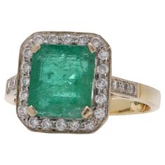 Vintage 18kt gold Zambian Emerald and diamond cluster ring. Made in 1998 Fully hallmarked. Dimensions - Ring Size (UK) = Q 1/2 (EU) = 58.5(US) = 8.75 Weight: 8.00 grams Emerald- Quantity: 1 Origin: Zambia Cut: Emerald Approx. Carat weight: 3.70 carats Diamonds - Quantity: 26 Cut: Round brilliant Tota carat weight: 0.52 carats Colour: E - F Clarity: VS1 Condition report: This pre-owned ring exhibits minimal signs of wear. Notably, it has been fitted with two small balls inside the band to reduce its size. Antique Emerald Ring, Vintage Cluster Ring, Auto Correct, Zambian Emerald, White Gold Engagement, Emerald Stone, White Gold Engagement Rings, Diamond Cluster Ring, Gem Stone