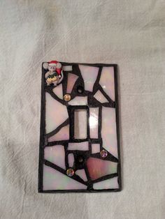 a stained glass light switch cover with a teddy bear on it