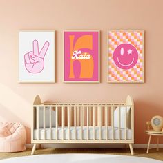 a baby's room with three posters on the wall and a crib next to it