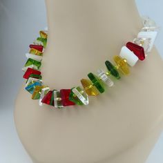 This unique necklace with its translucent abstract shapes is a celebration of light and color!  The geometric shapes include polygons, triangles, squares, and trapezoids.  The riot of colors include red, green, honey, turquoise, and white with a few clear in the mix.  The glass shapes resemble the pieces used to create a stained glass mosaic, but all the sides, edges, and corners are smooth.  Though the components appear complex, the necklace design is simple, allowing the glass shapes to speak Amazing Necklaces, Abstract Necklace, Magazine Vogue, Chic Necklace, Necklace Design, Creation Couture, Square Bead, Unique Necklace, Stained Glass Mosaic