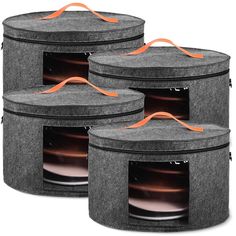 three round storage bins with orange handles