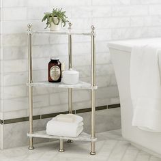 a bathroom with a white bath tub and marble shelving