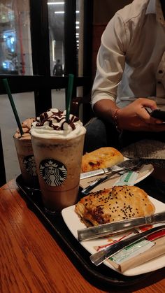 there is a tray with coffee and pastries on it, along with other items