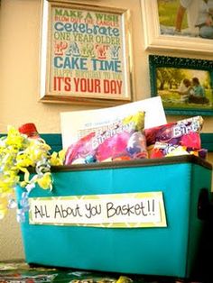 a blue box filled with candy sitting on top of a table next to framed pictures