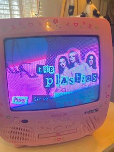 an old tv sitting on top of a table with the words plastics written on it