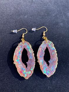 These pink opal geode inspired earrings are sure to get compliments or make an amazing one of a kind gift!  They are lightweight because they are made from resin and won't weigh down your ears. Please choose whether you would like gold or silver earwires, and the edges can be painted in a beautiful gold or silver metallic Clip on earrings are available as well Handmade by Katie  KG Design & Decor Please follow my on social media  Instagram: @KG_DesignandDecor Facebook: KG Design and Decor Please Agate Drop Earrings Gift, Agate Drop Earrings For Gift, Handmade Opal Drop Earrings, Agate Drop Earrings As A Gift, Iridescent Pierced Drop Earrings, Opal Pierced Earrings As Gift, Opal Earrings For Gift, Pink Opal Jewelry For Gift, Opal Earrings Perfect For Gifts