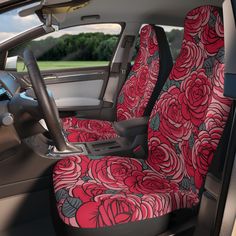 the interior of a car with red roses on it's seat covers and steering wheel