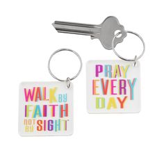 two keychains with the words pray, walk by faith and not by sight on them