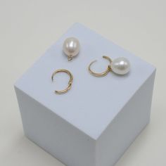 lightweight and graceful, our Paradise earrings are the ideal blend of quiet luxury and approachability. these elegant, 14kt solid gold huggie hoops are the perfect choice for any occasion. the delicate hoops are adorned with a genuine freshwater pearl, creating an air of sophistication and modernity. it is sure to become a timeless staple in your jewelry collection. the best part? since we love versatility, the pearl charm can be removed for a minimal look. you now have the perfect pair of ever Brazilian Gold, Synthetic Diamond, Gold Bond, Quiet Luxury, Pearl Charms, 14kt Gold, Cultured Pearls, Gold Vermeil, Precious Stones